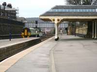 A morning Northern Rail service from Hull, formed by 158845, about to run past the camera towards the main platforms (3-5) accomodated within the trainshed at Scarborough station on 3 April 2008. This photograph, looking south away from the main station, shows part of the long and noteworthy platform 1 at Scarborough, a platform that has handled many an excursion train in its day. The platform has its own buildings in addition to those surrounding the main part of the station, as well as an impressive canopy standing over the central section of the platform with its own entrance/exit onto Westborough Road. Beyond the canopy, attached to the station wall, is what is claimed to be the longest railway station passenger bench in Europe. At 456 feet in length, this continuous bench has been known to accommodate a total of 228 average size bu.... err passengers...but not for some time.<br>
<br><br>[John Furnevel 03/04/2008]