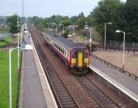 Opened in May 1989, Greenfaulds station stands on the southern edge of Cumbernauld. Scene looking southwest over the station on 30 August as 156 513 moves off with a Motherwell - Cumbernauld service.<br><br>[David Panton 30/08/2008]