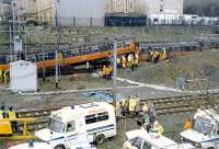 The aftermath of the Bellgrove crash in 1989. Two 303s met in a head on collision on the single lead from Bellgrove Junction. One driver and one passenger were killed. The Springburn bound train is to the left and that from Springburn underneath and to the right. The Airdrie line is in the foreground. [See image 33386]<br><br>[Ewan Crawford 06/03/1989]