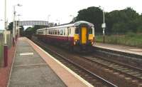 A Glasgow Central - Whifflet train arrives at Mount Vernon on 30 August formed by 156 433, as a freight heads west in the background towards Carmyle.<br><br>[David Panton 30/08/2008]