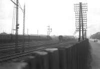 View west from Arkleston Junction along Gallowhill Road towards Paisley in 1966 as a black 5 (left of picture) moves a train of empty coaching stock off the Ayr line into one of the loops, while a classmate on the right takes a train on the Gourock line towards Gilmour Street station.<br><br>[Colin Miller //1966]