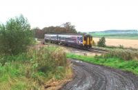 Situated a long way from the village it was supposed to serve, Singleton station closed in 1932. Until the 1990s a small signal cabin remained as an intermediate block post here but now only the approach road survives to identify the location and that is <I>clarty</I> to say the least as can be seen in this image of a 156 heading for Blackpool North. View towards Poulton-le-Fylde at Map Reference SD368369. <br><br>[Mark Bartlett 09/09/2008]