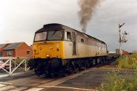 A departure from Felixstowe container depot crosses the road at Felixstowe Beach in 1990.<br><br>[Ewan Crawford //1990]