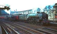 A1 Pacific 60118 <I>Archibald Sturrock</I> arrives at Carlisle with a train from the north in the 1960s passing a Black 5 standing on the centre road. The locomotive was doubtless working back to its home shed at Leeds via the Settle & Carlisle line. [60118 was transferred from Copley Hill to Neville Hill in 1963 during run-down of the former shed prior to its official closure the following year.]<br><br>[Robin Barbour Collection (Courtesy Bruce McCartney) //]