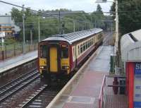 A wet day at Whifflet on 20 August 2008, as 156 514 runs into the Glasgow bound platform after reversal, following a short lie-over on the little used Whifflet South Junction - Sunnyside Junction freight only line running behind the arrival platform on the left.<br><br>[David Panton 20/08/2008]