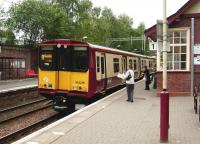 A newspaper is temporarily abandoned as 314 216 pulls into Whitecraigs on 7 June 2007 with a Neilston - Glasgow Central service.<br><br>[David Panton 07/06/2007]