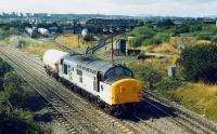 A single tank approaches Fouldubs Junction. In the background is the now closed Grangemouth MPD.<br><br>[Ewan Crawford //1990]