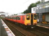 314 216 on a service to Motherwell via Singer stands under the well known platform Portakabins at Dalmuir in July 1997. The Portakabins survive 11 years on.<br><br>[David Panton 11/07/1997]