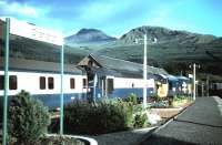 The southbound sleeper from Fort William stands at Crianlarich on a Summer evening in 1985 hauled by a class 37 locomotive accompanied by an ETHEL unit.<br><br>[Colin Alexander //1985]