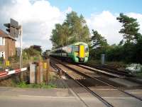 Just to the west of Fishbourne (Halt) is a second level crossing. 377426 leaves the station travelling towards Portsmouth and these days, although the line is busy, there is little variety of traction. Contrary to appearances this picture was taken legally.<br><br>[Mark Bartlett 13/09/2008]