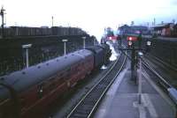 A BR Standard class 5 takes a Glasgow train out of Dundee c late 50s/early 60s. The former NB and Caledonian goods yards are on the left and right respectively, Dundee West signalbox can be seen through the smoke in the centre of the picture and the coaling plant at 62B stands on the horizon.<br><br>[Robin Barbour Collection (Courtesy Bruce McCartney) //]