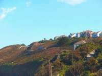 The <I>Bubble Car</I> from St Ives is climbing along the cliffs above Carbis Bay but beyond the cutting will drop down to sea level at Lelant. The dramatic changes of scenery on this short line are remarkable. <br><br>[Mark Bartlett 18/09/2008]