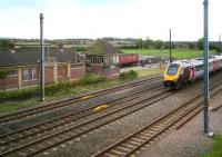 A CrossCountry Voyager passing Otterington on the down ECML approaching Northallerton on 3 October 2008. The station closed to passenger traffic in 1958 and is now, along with the signal box, goods yard and Mk2C BFK coach, in private ownership. The historic signal box dates from the 1930s and played a key role in the development of colour light signalling. A 1939 LNER publication urges passing rail travellers to note <I>...the first of the LNER wonder signal boxes...from here is controlled four and a half miles of track...the signalman sits at a control panel and electrically operates points and signals using small switches</I>...<br><br>[John Furnevel 03/10/2008]