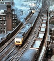 Looking east from the Castle Keep in Newcastle in 1971 as a North Tyneside DMU heads towards Manors. Approaching Central Station with a passenger train is a green Brush Type 4, which is in the process of passing a green EE Type 3 on coal empties. Theres even a green Gateshead bus coming off the Tyne Bridge in the background!<br><br>[John Alexander //1971]