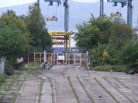 Looking over the site of Princes Pier Shed, latterly in use as container sidings for the Greenock Ocean Terminal. The bridge in the centre of shot goes over Brougham Street (See image 8933 and 15507) and ran into Princes Pier Station. It has been converted for use as a road bridge and for use with the run round loop. The signal box was to the right of the bridge, and signal gantry was at the end of the bridge. <br><br>[Graham Morgan 20/09/2008]