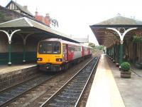 Knaresborough station looking towards Harrogate as 3-car 144020 waits to depart for Leeds. Beyond the train the crossover on the Nidd viaduct can be seen. A fireplace business occupies most of the buildings on the York platform, and the station is in excellent condition. <br><br>[Mark Bartlett 11/10/2008]