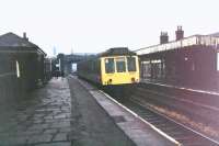 A Derby DMU calls at New Hey on the Oldham loop in this view towards next stop Milnrow in February 1972. At this time the station and line were under threat of complete closure but were later reprieved by Greater Manchester PTE to survive up to 2009. The station and line then closed and were reopened under the Metrolink tram system in 2013 [See image 21080] for a 2008 comparison, just prior to main line closure.<br><br>[Mark Bartlett /02/1972]