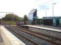 The strange looking building alongside the line at Old Trafford is actually the scoreboard, which illustrates how close the cricket ground is to the station. View south towards Altrincham. This line has had three different overhead electrification schemes. 1500v DC to 1971 followed by 25kv AC until converted to the Metrolink tramway at 750v DC. [See image 29619] to see how this location has since been altered with new staggered platforms. <br><br>[Mark Bartlett 17/10/2008]