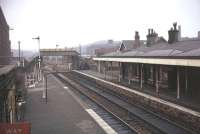 Shaw and Crompton in 1972, still lit by gas lamps and with original buildings and awnings intact. Never under threat of closure it was however at this time planned to become the terminus of a stub from Manchester and Oldham but the link to Rochdale was reprieved, albeit the line was singled in 1980. View towards Oldham and Manchester. [See image 21125] for a 2008 comparison.<br><br>[Mark Bartlett /02/1972]