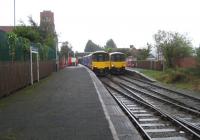 Last week of the 15 minute service. For many years Shaw and Crompton has enjoyed a four trains per hour service to Manchester, two of which run fast only stopping at Oldham Mumps. However, October 2008 that will change to a half hourly stopping service as work continues in preparation for conversion to Metrolink. View towards Manchester as a four car Sprinter waits to go forward to Oldham and another Sprinter draws forward onto the single line section to Rochdale.<br><br>[John McIntyre 30/09/2008]