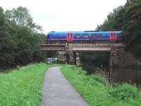 Although the Lancaster Canal runs near to the WCML for much of its length this bridge just south of Lancaster Castle station is the only point where the active section of the canal crosses the railway. A northbound Trans Pennine 185 unit drops down the bank towards its stop at Lancaster on 10 September. (Map Ref SD 474609)<br><br>[Mark Bartlett 10/09/2008]