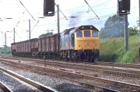 Only a fairly short fitted freight but 25135 is clearly working hard on the Up Fast line immediately north of Leyland in June 1981. The former D5285 was withdrawn in Janury 1983 but lingered around until being cut up at Swindon in August 1986. <br><br>[Mark Bartlett 10/06/1981]