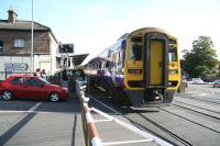 The late running 07.39 Gilberdyke - Scarborough train runs over the crossing on River Head Drive and into Driffield station on 1 October 2008.<br><br>[John Furnevel 01/10/2008]