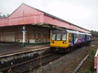 By 2008 the Oldham Mumps track layout had been simplified to a basic two lines, albeit still controlled by semaphores. However, a substantial island station remained, accessed by a subway. 142060 is departing for Shaw and Crompton. After closure in 2009 everything seen here was cleared away and a temporary tram stop opened in 2012 pending completion of the street running section in Oldham Town Centre. <br><br>[Mark Bartlett 30/09/2008]