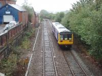 The trees on the right hide the 1842 formation of the 1:27 Werneth or Chadderton incline down to Middleton Junction, finally closed completely in 1963. 142011 has come up the easy way via the 1880 route at only 1:50 through Failsworth and Hollinwood on a stopping service for Shaw & Crompton. This view was taken in 2008 before conversion to Metrolink use. The trams negotiate the 30mph curve a little quieter than the Pacers! <br><br>[Mark Bartlett 30/09/2008]