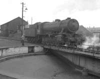 Austerity 2-8-0 90020 of 62A Thornton Junction backs off the turntable at Ferryhill shed in July 1963.<br>
<br><br>[Colin Miller 12/07/1963]