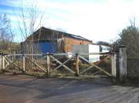 The level crossing gates and goods shed at Appleby East in February 2007. The station is to the right of the picture (towards Warcop). Passenger services were withdrawn in 1962 but freight remained between Appleby and Hartley Quarry until 1974 when it was cut back to Warcop serving the Army camp and training area until 1989. Appleby East yard and station is now the site of a local recycling company although the present Eden Valley Railway hopes to reopen the line from its base at Warcop to Appleby East.<br><br>[John McIntyre 18/02/2007]