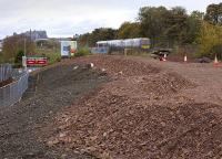 Standing on the site of Balgreen Halt looking east on 27 October 2008 with Edinburgh Castle on the horizon. The trackbed preparations are being carried out in connection with the forthcoming Edinburgh tram system. An approaching DMU is crossing the bridge over Balgreen Road westbound on the E&G, a route along which the trams will eventually run in parallel as far as Saughton.<br><br>[Bill Roberton 27/10/2008]