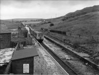 The closure notices are posted and it is the last week of services on the Rawtenstall branch. A Newton Heath Cravens twin power-car DMU approaches Ewood Bridge and Edenfield from Rawtenstall on a Bury Bolton Street service. The distant signal (fixed) is for Townsend Fold level crossing just south of Rawtenstall. The line had been singled two years previously and the slew from Up to Down line can be seen behind the train. [See image 21792] for a modern day 'Then and Now' comparison. <br><br>[W A Camwell Collection (Courtesy Mark Bartlett) 27/05/1972]