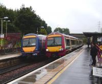 Edinburgh and Glasgow service pass at Croy on a wet 18 August 2007.<br><br>[David Panton 18/08/2007]