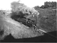 Holcombe Brook bound push pull set with L&YR 2-4-2T 50655 climbing through the cutting between Woodhill Rd Halt and Brandleshome Rd Halt (SD 797117). The line was electrified in L&Y days but the equipment was worn out by 1951 and with only a short life expectancy the branch reverted to steam haulage from 1951 until closure. This photo was undated but believed to have been taken on the last weekend of service, 3rd May 1952. (A visit in December 2008 found the cutting filled in up to the level of Brandlesholme Road and a housing development under construction.)<br><br>[W A Camwell Collection (Courtesy Mark Bartlett) 03/05/1952]