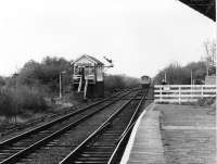 A Cravens DMU heads away from Rainford Junction on the single line section to the Merseyrail interchange at Kirkby. The DMU is just about at the point where the direct line from Ormskirk to St. Helens passed over this line. The curving platform seen here was used by passenger trains to Ormskirk until 1951 and a mirror platform on the other side catered for St. Helens services until the same year. Rainford Junction is largely unchanged today and the signalman still emerges from the box to hand over or collect the staff from trains on the single line stub. [See image 27639] <br><br>[Mark Bartlett 03/11/1980]