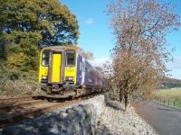 153304 and a second Northern Rail <I>bubble car</I> accelerate away from Grange-over-Sands, alongside the promenade, on a train for Carlisle via Barrow in Furness and the Cumbrian Coast.<br><br>[Mark Bartlett 01/11/2008]