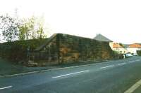 Remnants of the Paisley & Barrhead District Railway photographed in the Summer of 2004. The northern abutment of the bridge that carried the line over Barshaw Drive, Paisley, since demolished to make way for a road and new housing.<br><br>[Colin Miller //2004]