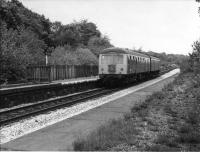 A Cravens DMU calls at Stubbins on its way from Bury Bolton Street to Rawtenstall in 1972. These Newton Heath allocated twin power-car Class 105 sets were the mainstay of branch services for many years, sometimes substituted by Derby 108 units. The rails of the closed Accrington line can just be seen beyond the platform. This line climbed steeply alongside the Rawtenstall and Bacup line for some distance before swinging to the North West and away from the Irwell Valley towards Helmshore. View towards Ewood Bridge and Edenfield.<br><br>[W A Camwell Collection (Courtesy Mark Bartlett) 27/05/1972]