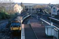 In the late 1980s, the weekday 07.10 Dunblane to Edinburgh service was a 47/7 Push-Pull duty. The train arrived from Stirling in the bay platform at Dunblane shortly after 06.30 and then reversed at Dunblane North Box. This view was taken around 06.45 one morning in April 1989 when the temperature was so low that diesel had frozen in the tanks of lorries parked nearby. <br><br>[Mark Dufton /04/1989]