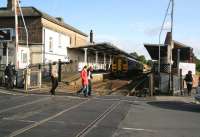 The crossing barriers are raised at Driffield on 1 October as a Scarborough train boards at the platform. [I happen to know a young Peter Todd spent many happy hours at this very spot between the late 50s and mid 60s watching a myriad of Summer Seaside Specials hurry by to destinations such as Bridlington, Filey and Scarborough. The highlight he recalls would have been Gresley A3 Pacific 60038 <I>Firdaussi</I> rushing through and the lowlight probably an Austerity 2-8-0 clanking by on an excursion from Leeds.]     <br><br>[John Furnevel 01/10/2008]