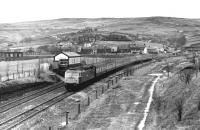 New Years Eve at Diggle sees 47511 <I>Thames</I> on a Newcastle to Liverpool service running down past Diggle Junction signal box just after leaving the Standedge tunnel. It can be bleak in this area but the weather was kind to us on this occasion. <br><br>[Mark Bartlett 31/12/1980]