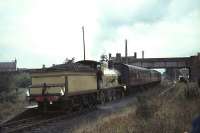 HR 103 stops at Lochmaben with a BLS railtour on 17 October 1965 running tender first from Dumfries to Lockerbie. The bridge carried the B7020 across the station site [see image 35752]. Protruding above the first coach beyond the bridge are the chimneys of the old station house and offices, out of use by this time, while the upper part of the Railway Inn is visible on the far left of the picture.<br><br>[G W Robin 17/10/1965]