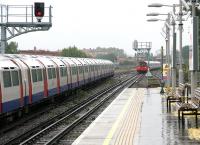 Piccadilly Line tube trains about to pass in heavy rain just east of Turnham Green station on 21 July 2005. The temporary eastern terminus of the line at that time was at Hyde Park Corner, following the bombing of a westbound Piccadilly Line train in the tunnel approaching Russell Square station 14 days earlier which resulted in the deaths of 26 people.<br><br>[John Furnevel 21/07/2005]