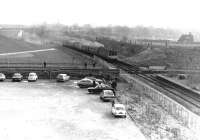 The flat crossing at Bury Knowsley Street had a short life span as traffic serving the coal concentration depot at Rawtenstall came to an end fairly soon after it had been installed. To mark the closure of the route, a  Rossendale Farewell Railtour was run from Manchester to Rawtenstall on 14 February 1981. The westbound 6-car DMU is seen here drawing forward towards the crossing on its outward journey having been held awaiting a suitable gap in the 15 minute frequency Bury - Manchester Victoria electric services. The flat crossing was removed not long after closure of the freight route, with the subsequent reopening of the line by the East Lancashire Railway resulting in the construction of its famous ski jump at this point, over what are now Metrolink tracks.<br>
<br><br>[Mark Bartlett 14/02/1981]