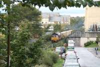 Looking west from the footbridge at the corner of Dryden Street in October 2006, as EWS 66233 takes a train of loaded refuse containers away from Powderhall depot on a Friday afternoons only <I>relief Binliner</I> working to Oxwellmains.<br><br>[John Furnevel 27/10/2006]