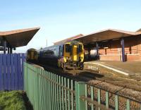 Northern Rail 156s call at Chorley on 16 November. On the right is a service to Buxton via Manchester while on the left is a service for Blackpool. The photograph is taken from the site of the former level crossing.<br><br>[John McIntyre 16/11/2008]