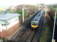 The view of Morecambe Bay from the train opens out as a Manchester Airport TPE service, formed by 185124, approaches the level crossing at Hest Bank. This gives access to the foreshore area that can be seen above the signal box. The view from the footbridge is towards Bolton-le-Sands, where another level crossing is also controlled from Hest Bank.<br><br>[Mark Bartlett 15/11/2008]