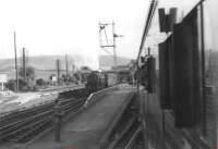 View of Gleneagles on 4 July 1964, its last day as a junction. Comrie train hurries in while 44850 waits with a northbound connection on the main line.<br><br>[John Robin 04/07/1964]