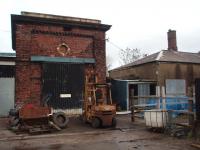 The base of the old water tower at Carnforth MR Shed, closed in 1944, still stands and has been converted into a small workshop. The building to the right was also part of the old shed complex.   <br><br>[Mark Bartlett 20/11/2008]
